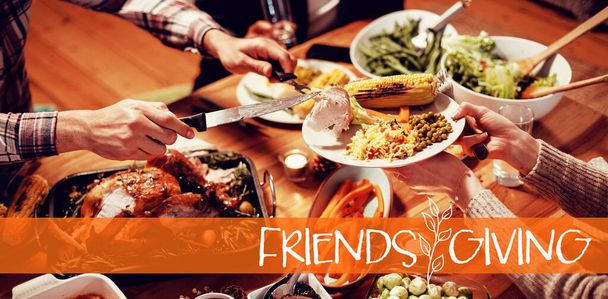 Happy Friendsgiving against friends celebrating thanksgiving together at home - 写真・画像