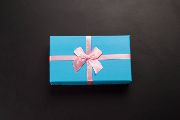 top view blue gift box on a black background - Zdjęcie, obraz