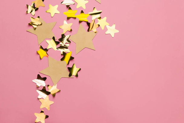 golden stars on a pink background with free space for text - Φωτογραφία, εικόνα