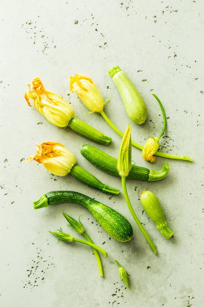 Fresh raw wet baby zucchini with flowers - gardening - 写真・画像