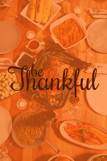 Thanksgiving greeting text against thanksgiving dinner on the table at home - Foto, Imagem
