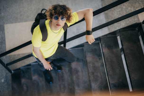 Stylish handsome teenager on steps outdoors stock photo - Φωτογραφία, εικόνα