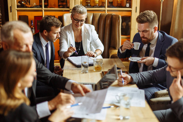 Group of businessmen brainstorming at meeting - Photo, Image