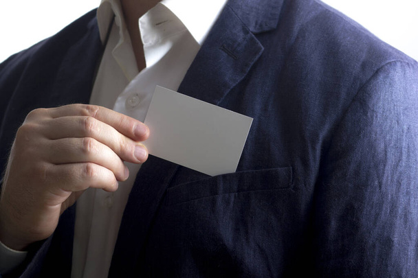 Hand holding white business card on white background - Foto, Imagem