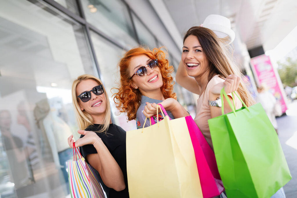 Group of happy smiling friends shopping in the city and having fun - Фото, изображение