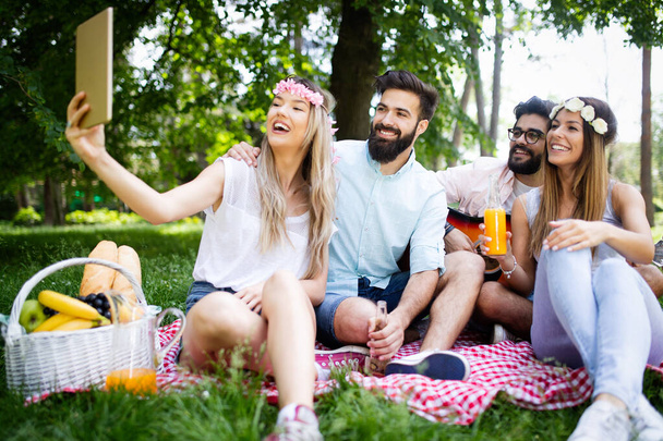 Friends having great time on picnic in nature - Zdjęcie, obraz