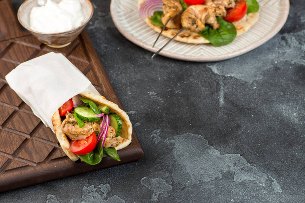 Souvlaki with vegetables wrapped in pita - Photo, image