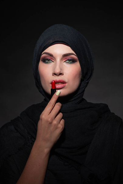 Portrait of arab woman painting her lips - Photo, Image