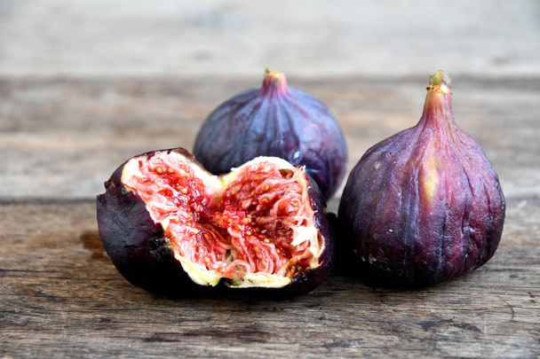 Ripe broken figs on old wooden boards. - Photo, Image