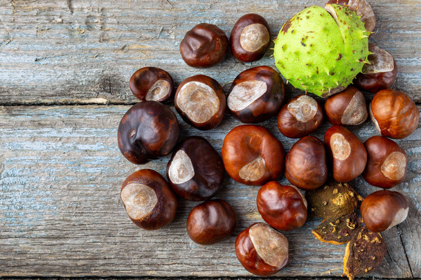 Still life of chestnuts on arustic wood table. - Photo, Image