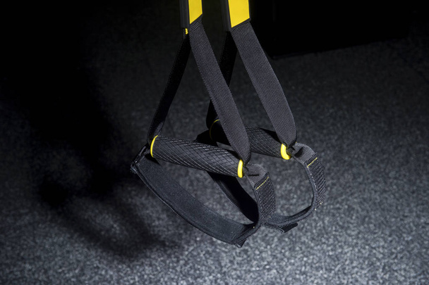 Training strap equipment. Black strap functional training equipment on grey background - Foto, immagini