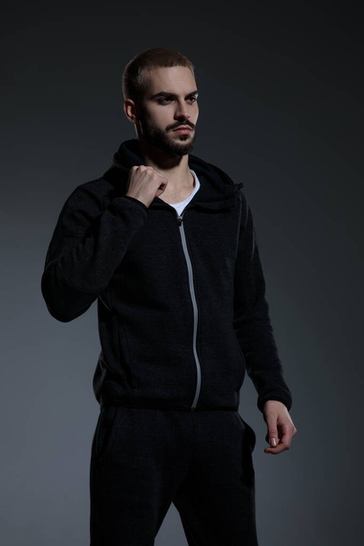 young fashion model wearing gym suit and fixing jacket - Foto, Imagem