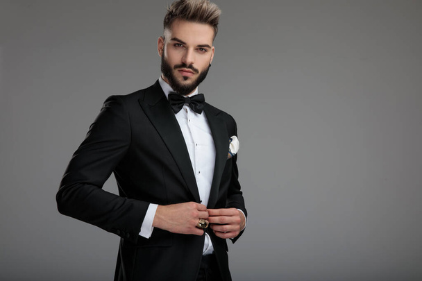 Confident groom unbuttoning his jacket - Foto, immagini