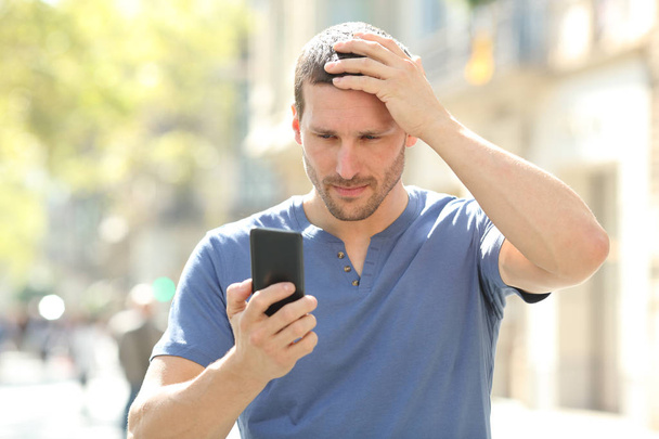 Confused man complaining after mistake checking phone - Photo, Image