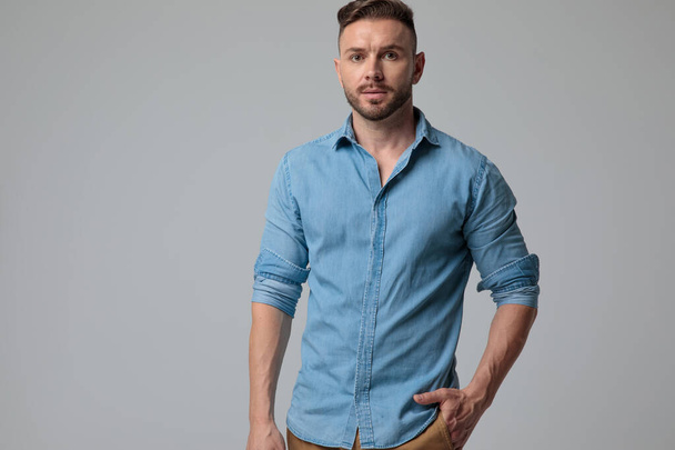 casual man standing with one hand in pocket serious - Photo, Image