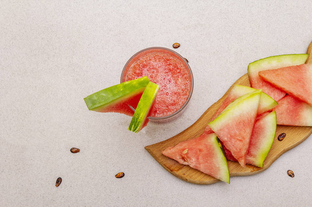 Fresh juice of watermelon, smoothie, cocktail. Sweet summer dessert, slices on wooden cutting board - Photo, Image