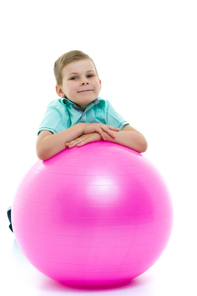 Cute boy playing with fit ball isolated on white - Photo, Image