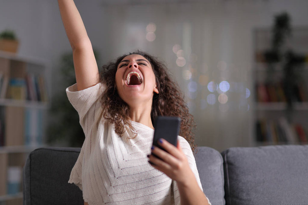 Excited woman celebrating success holding mobile phone - Foto, Imagem