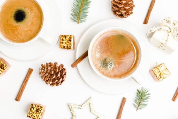 Top view of a cup of coffee, isolate on white with Christmas toys, pine cones, cinnamon, and New Year decor - Zdjęcie, obraz