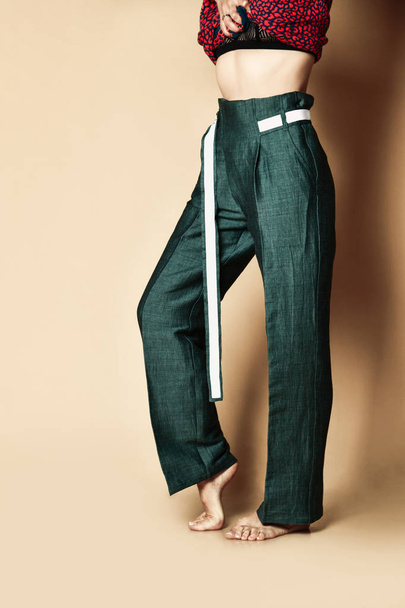 New design woman green pants casual girl apparel wear with belt on beige  - 写真・画像