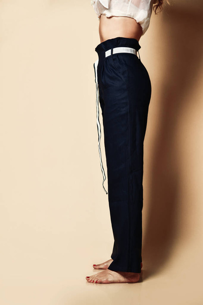 New design woman black pants casual girl apparel wear with belt on beige  - Fotoğraf, Görsel