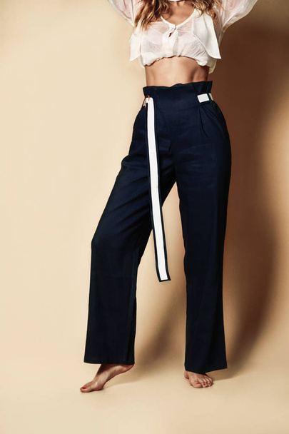 New design woman black pants casual girl apparel wear with belt on beige  - Fotoğraf, Görsel