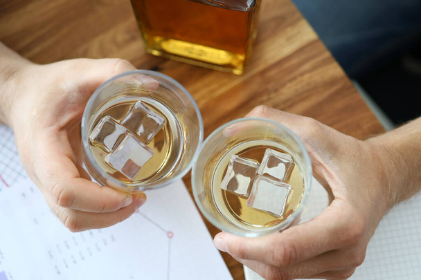 Glass of whiskey in office - 写真・画像