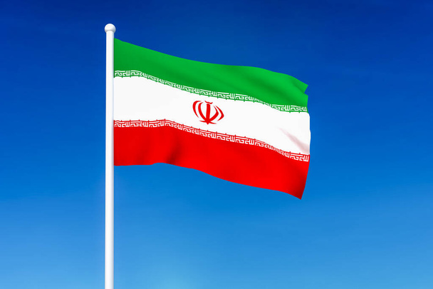 Waving flag of Iran on the blue sky background - Photo, Image