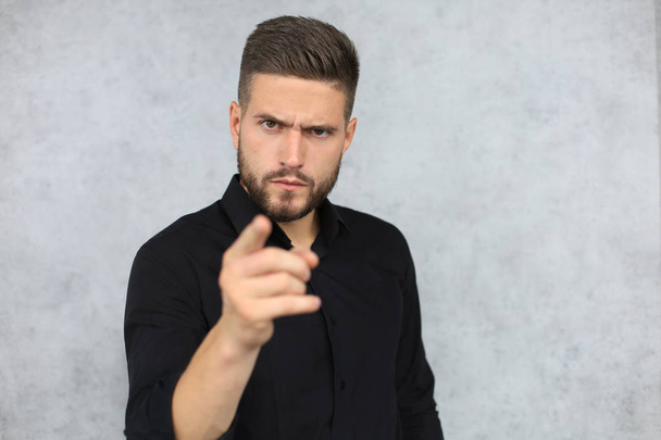 Confident business man is pointing finger at you isolated over gray background - Foto, Imagem
