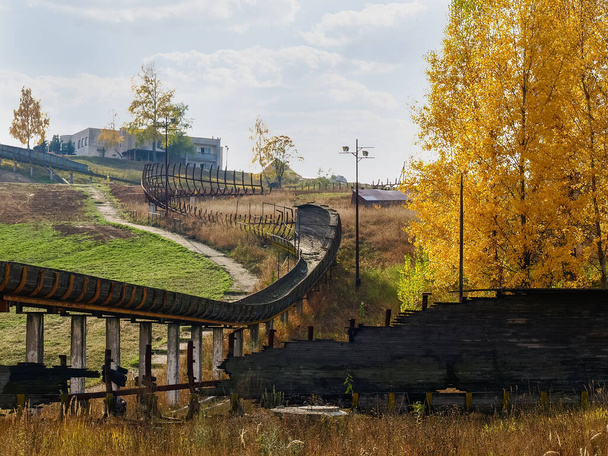 Ruins of the old wooden luge track in autumn - Photo, Image