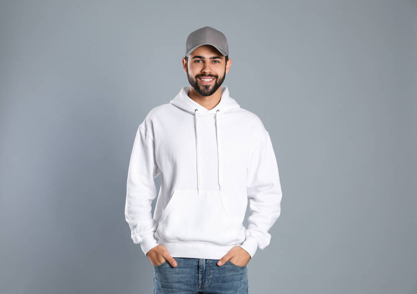 Portrait of young man in sweater on grey background. Mock up for design - Foto, Imagen