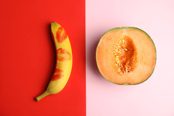Flat lay composition with fresh banana and melon on color background. Sex concept - Photo, image
