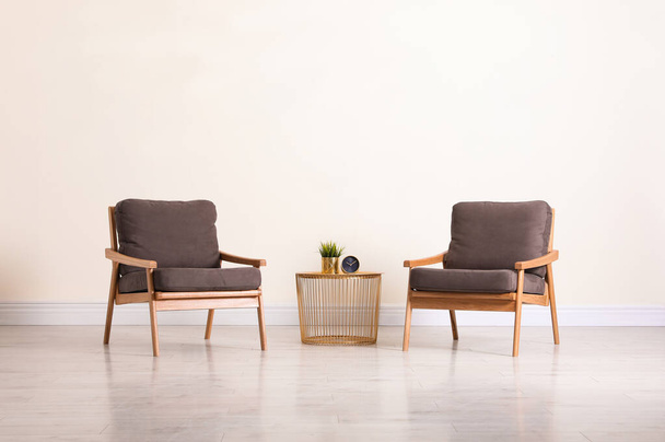 Stylish living room interior with comfortable furniture near beige wall - Zdjęcie, obraz