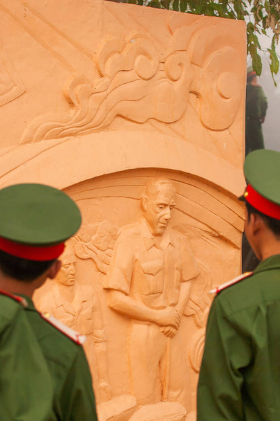 Portrait of young vietnamese soldier in green uniform looking at - Photo, Image