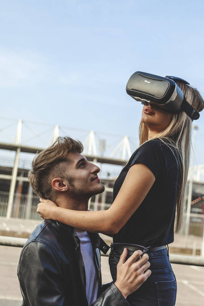 beautiful couple in love hugging with glasses of virtual reality - Foto, Imagen