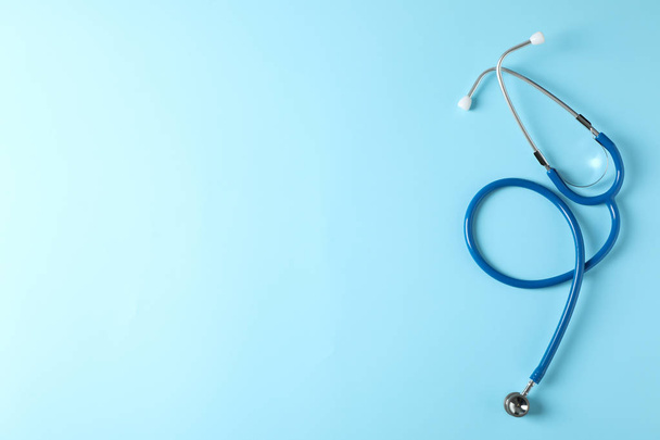 Stethoscope on blue background, top view and space for text - 写真・画像
