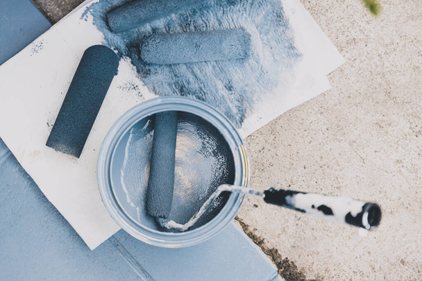 empty tin of muted blue paint next to newly painted tfloor tiles - Photo, Image