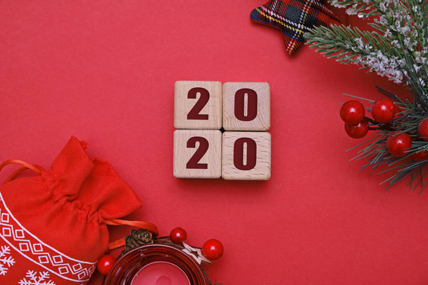 Christmas and new year 2020 concept, wooden cubes and decorations on red background - Zdjęcie, obraz