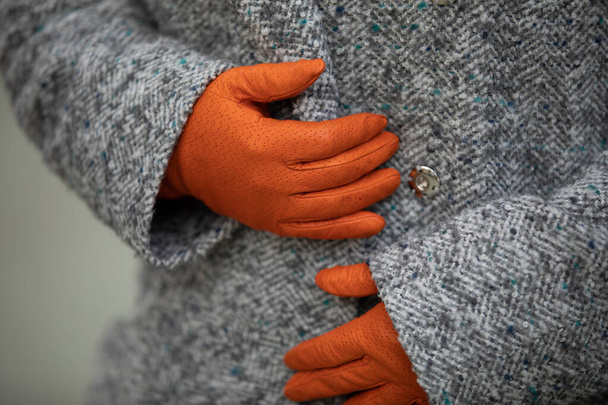 Tyttö oranssi klassinen käsineet ja hanhi jalka takki
 - Valokuva, kuva