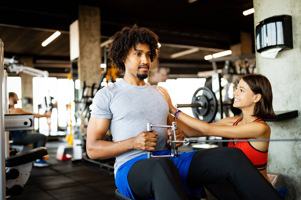 Teamwork in gym. Couple working exercise together. Healthy life concept - Photo, Image