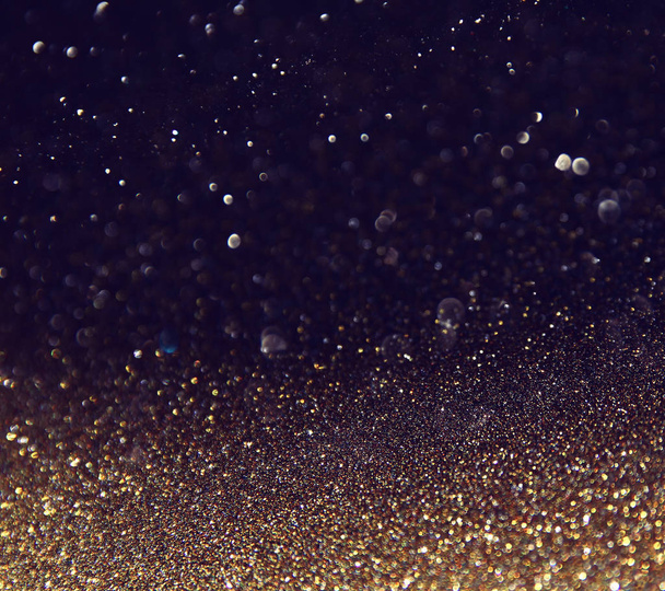 background of abstract glitter lights. gold and black. de focused - Photo, Image