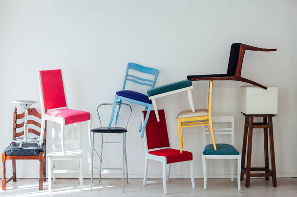 many different chairs stand in the white room - Photo, Image