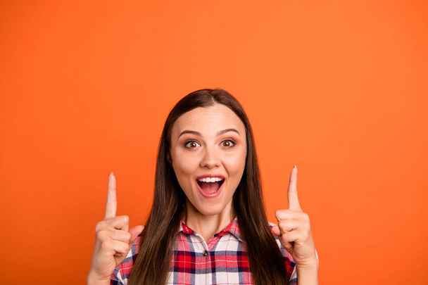 Close-up portrait of her she nice attractive lovely cheerful glad straight-haired girl pointing two forefingers up tips feedback isolated on bright vivid shine vibrant orange color background - Foto, Imagen