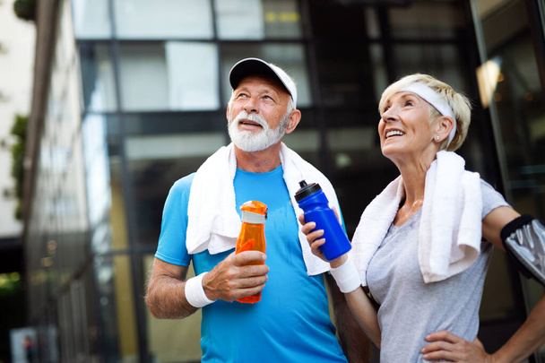 Healthy senior couple jogging in the city at early morning - Fotoğraf, Görsel