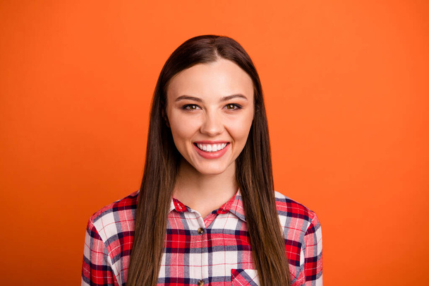Close-up portrait of her she nice attractive lovely winsome cheery glad content straight-haired girl wearing checked shirt isolated over bright vivid shine vibrant orange color background - Фото, зображення