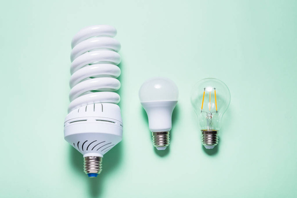 Set of different energy saving lamp on mint background - Φωτογραφία, εικόνα
