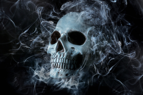 Human skull with smoke on dark background - Photo, Image