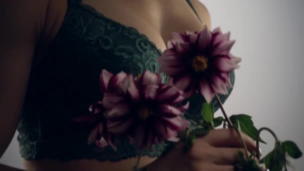 Woman in green lingerie with flower - Filmati, video