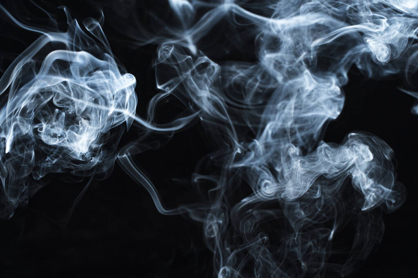 Photo of a wisp of smoke on a dark background - Foto, Imagem