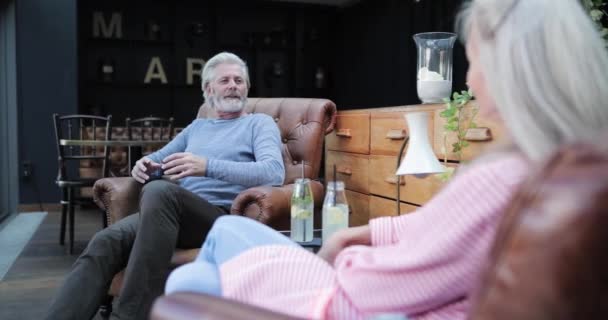 Senior Adult Couple relaxing in lobby of Luxury Hotel - Felvétel, videó